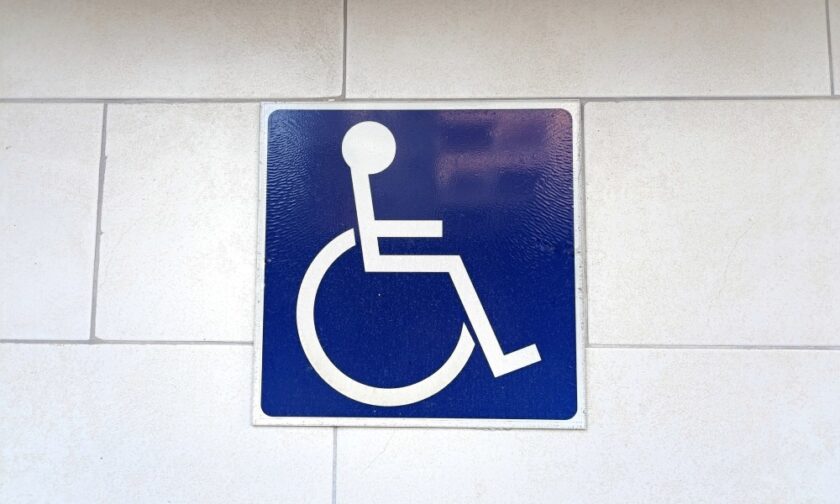 A wheelchair symbol appears on a blue background tile. There are white rectangular tiles around the blue symbol.